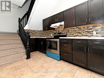 Ottawa apartment for rent - A kitchen with a stove and cabinets.