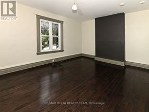 Ottawa apartment for rent - A room with a window and wooden floors.