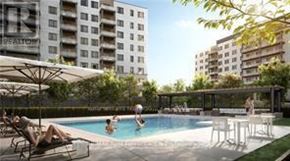 Guelph (Willow West/Sugarbush/West Acres) condo for rent - A pool with people relaxing in it and a building in the background.
