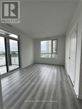 Guelph (Willow West/Sugarbush/West Acres) condo for rent - A room with a wooden floor and a sliding glass door.