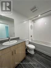 Guelph (Willow West/Sugarbush/West Acres) condo for rent - A bathroom with a toilet, sink, and bathtub.