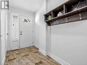 Toronto (St. Andrew-Windfields) townhouse for rent - A hallway with a white door and a wooden shelf above it.