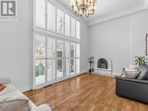 Toronto (St. Andrew-Windfields) townhouse for rent - A living room with a fireplace and a couch.