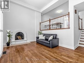 Toronto (St. Andrew-Windfields) townhouse for rent - A living room with a fireplace and a couch.