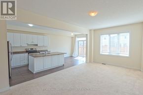 Essa (Angus) apartment for rent - A spacious kitchen and living room with white cabinets and a large island.