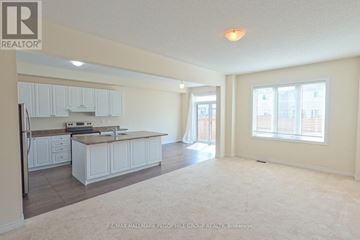 Essa (Angus) apartment for rent - A spacious kitchen and living room with white cabinets and a large island.