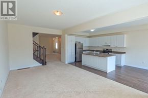 Essa (Angus) apartment for rent - A spacious living area with a kitchen in the background.