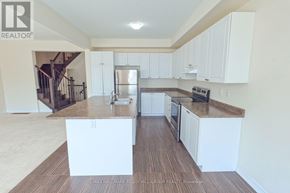 Essa (Angus) apartment for rent - A kitchen with white cabinets and a wooden floor.