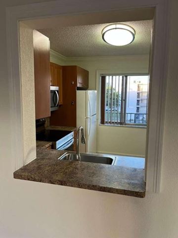 Miramar apartment for rent - A kitchen with a sink and a refrigerator.
