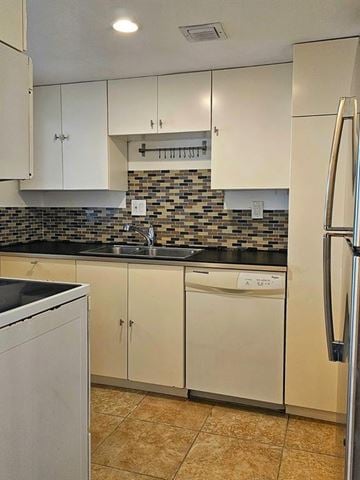 North Miami Beach apartment for rent - A kitchen with white cabinets and a black counter top.