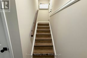 Woodstock (Woodstock - North) apartment for rent - A staircase with wooden steps and a white wall.