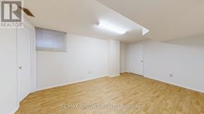 Toronto (Agincourt South-Malvern West) apartment for rent - A room with wooden flooring and white walls, with a window covered by a white blind.