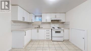Toronto (Agincourt South-Malvern West) apartment for rent - A white kitchen with a stove top oven and a refrigerator.