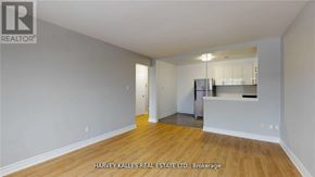 Toronto (Keelesdale-Eglinton West) apartment for rent - A spacious room with wooden flooring and a kitchenette in the corner.