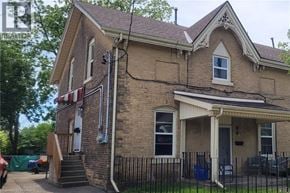 Brantford apartment for rent - A house with a wooden staircase leading to a door.