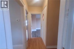 Brantford apartment for rent - A hallway with a door at the end.