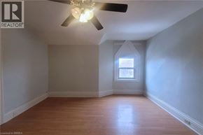 Brantford apartment for rent - A room with a ceiling fan and a window.
