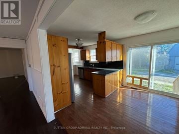 Richmond Hill apartment for rent - A kitchen with wooden cabinets and a black countertop is shown in this image.