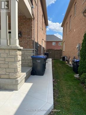 Caledon apartment for rent - A residential area with a house and a trash bin.