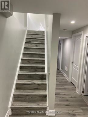 Caledon apartment for rent - A staircase with wooden steps and white railings.