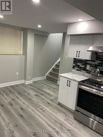 Caledon apartment for rent - A kitchen with a stainless steel oven and white cabinets.