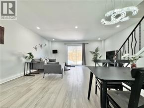 Kitchener townhouse for rent - A well-lit living room with a dining table and chairs.