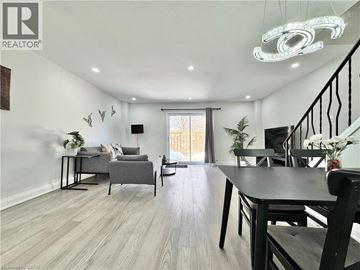 Kitchener townhouse for rent - A well-lit living room with a dining table and chairs.