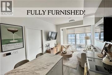 Kitchener apartment for rent - A fully furnished living room with a flat screen TV and a coffee table.