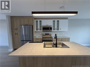 Shediac townhouse for rent - A kitchen with a sink and a refrigerator.