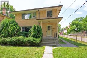 London North (North R) duplex for rent - A house with a front yard and a sidewalk leading to the front door.