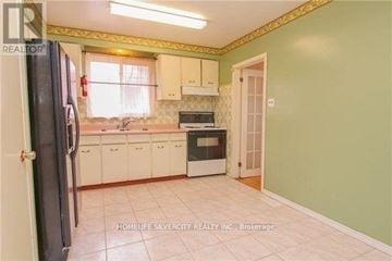 Toronto (Thistletown-Beaumonde Heights) apartment for rent - A kitchen with green walls and white cabinets.