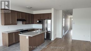 Welland (Dain City) apartment for rent - A kitchen with brown cabinets and a white countertop.