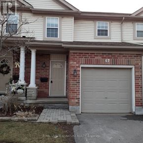 Kitchener townhouse for rent - A house with the number 67 on the garage door.