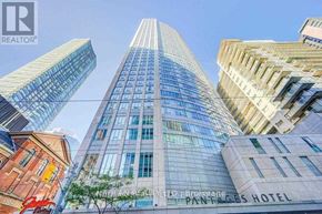 Toronto (Church-Yonge Corridor) condo for rent - A tall building with the words Painted Pages Hotel on it.