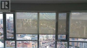 Toronto (Church-Yonge Corridor) condo for rent - A kitchen with wooden cabinets and a white refrigerator.