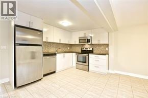Hamilton apartment for rent - A kitchen with a refrigerator, microwave, oven, and sink.