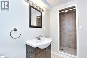 Hamilton apartment for rent - A bathroom with a sink, mirror, and shower.