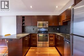 Vancouver apartment for rent - A modern kitchen with dark wood cabinets and stainless steel appliances.