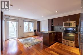 Vancouver apartment for rent - A modern kitchen with dark wood floors and stainless steel appliances.