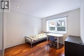 Vancouver apartment for rent - A bedroom with a bed, desk, and chair.