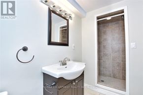 Hamilton (Huntington) apartment for rent - A bathroom with a sink, mirror, and shower.