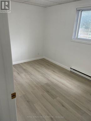 Cobourg multi-family for rent - A room with a wooden floor and a window.