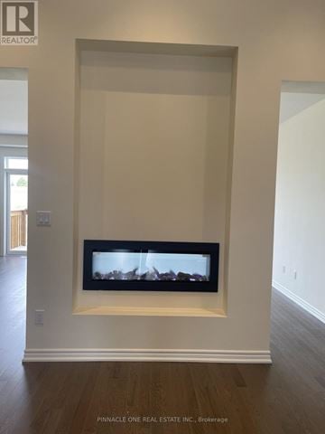 Oshawa (Kedron) apartment for rent - A living room with a fireplace and a tv mounted on the wall.