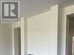 Oshawa (Kedron) apartment for rent - A white door with a Realty sign above it.