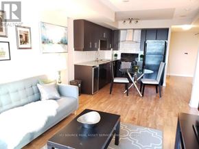 Toronto (Bendale) condo for rent - A modern kitchen with a white couch and a black coffee table.