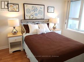 Toronto (Bendale) condo for rent - A bedroom with a bed, nightstands, and pictures on the wall.