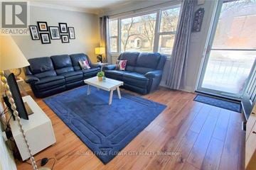 Kitchener apartment for rent - A living room with a blue rug and a white coffee table.