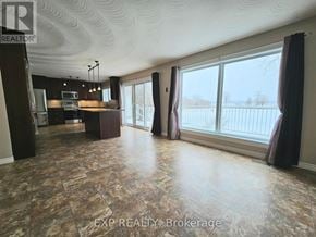 Deseronto (Deseronto (Town)) apartment for rent - A spacious room with a large window and a view of a fence.