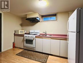 Hamilton (Westcliffe) apartment for rent - A kitchen with white appliances and wooden floors.