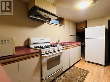 Hamilton (Westcliffe) apartment for rent - A kitchen with a white stove and a white refrigerator.